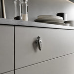 Afbeelding laden in galerijweergave, Chrome silver carrot knob on a gray drawer