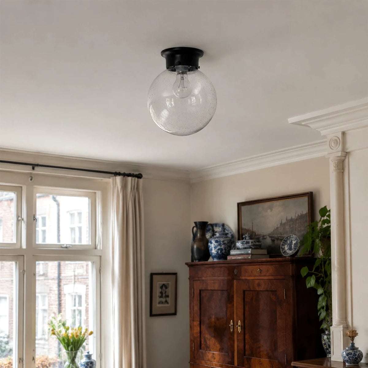 Glass ceiling lamp installed close to the ceiling in a classic room