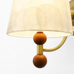 Carica l'immagine nella visualizzazione Galleria, Close-up of warm wood sphere accents below the shell shade
