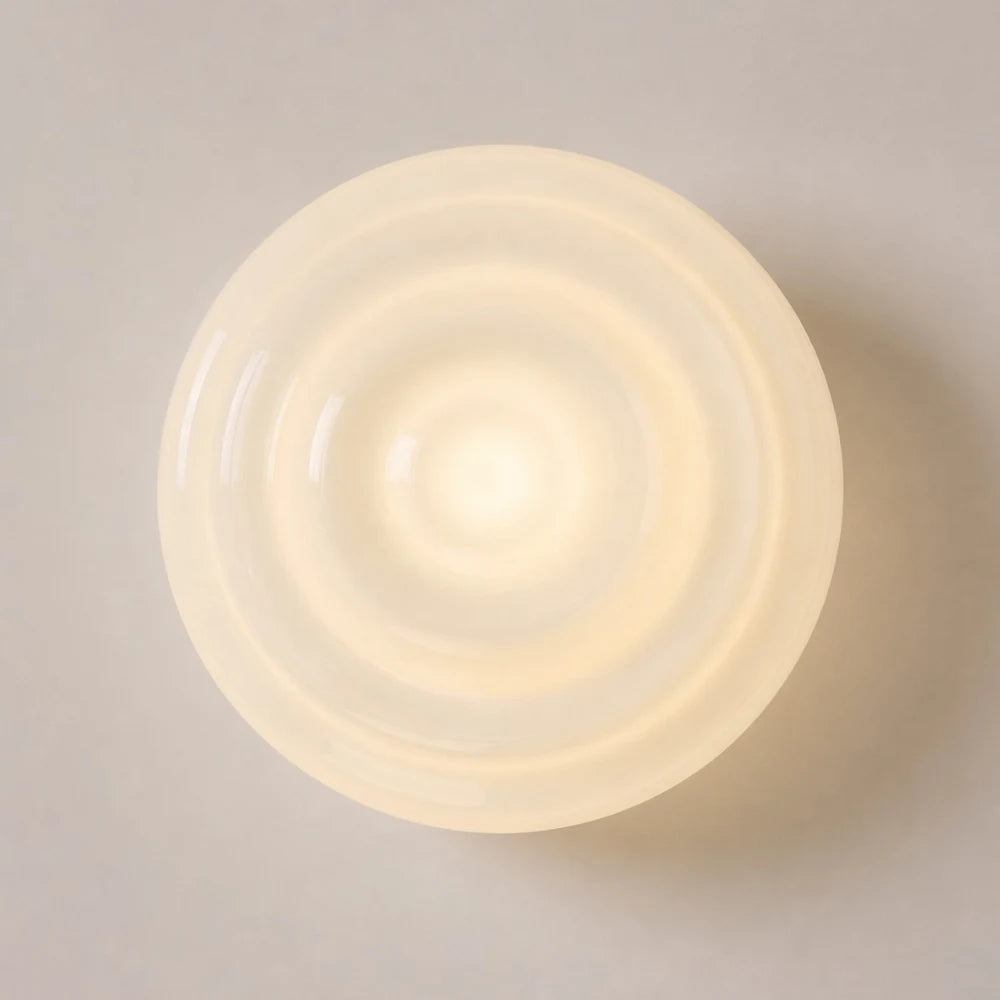 Warm glowing ribbed glass wall lamp front detail