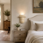 Charger l'image dans la visionneuse de la galerie, Travertine wall sconce used beside a bed as a warm bedside wall light