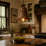 Rust bell pendant light over a warm kitchen island