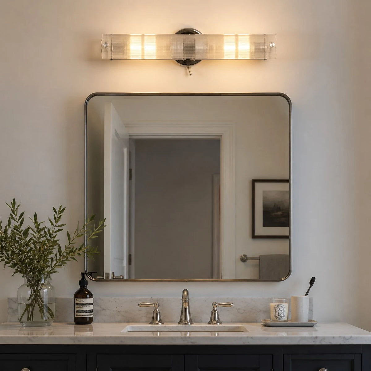 Double glass wall light above a bathroom mirror