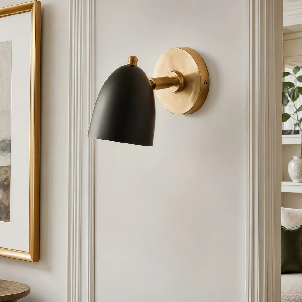 Black and gold wall sconce on a refined wall