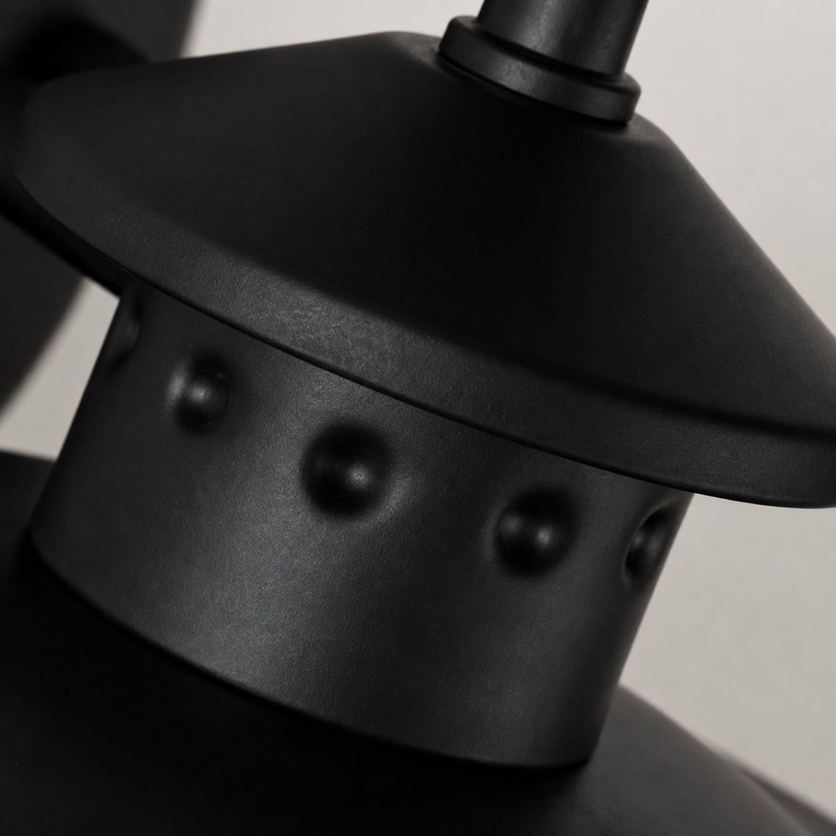 Black riveted metal cap detail