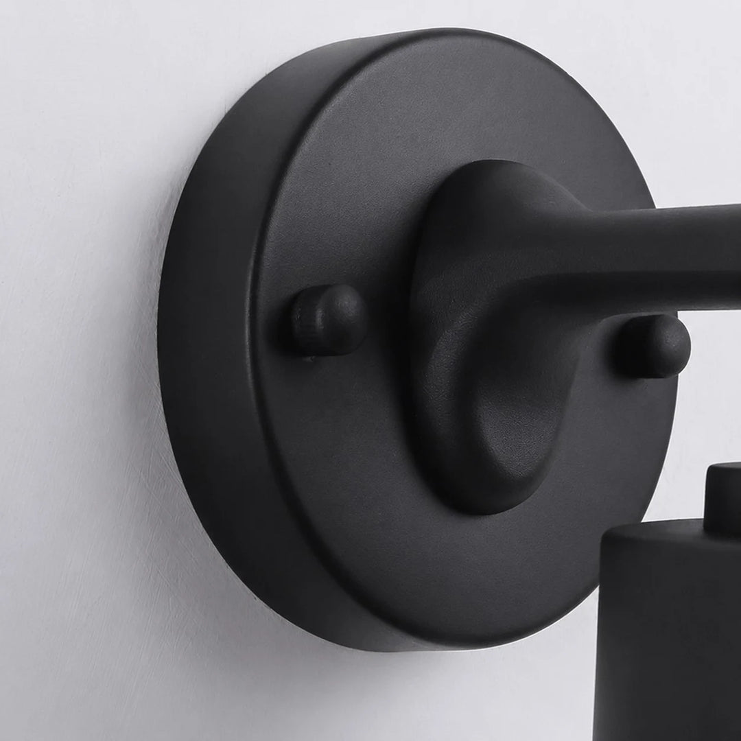 Close view of the black round wall plate and metal arm