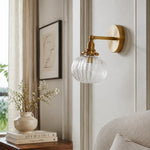 Cargar imagen en el visor de la Galería, Brass ribbed glass wall light in a calm bedroom corner