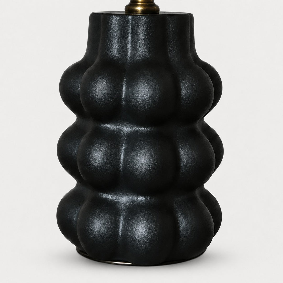 Sculpted matte black ceramic lamp base detail