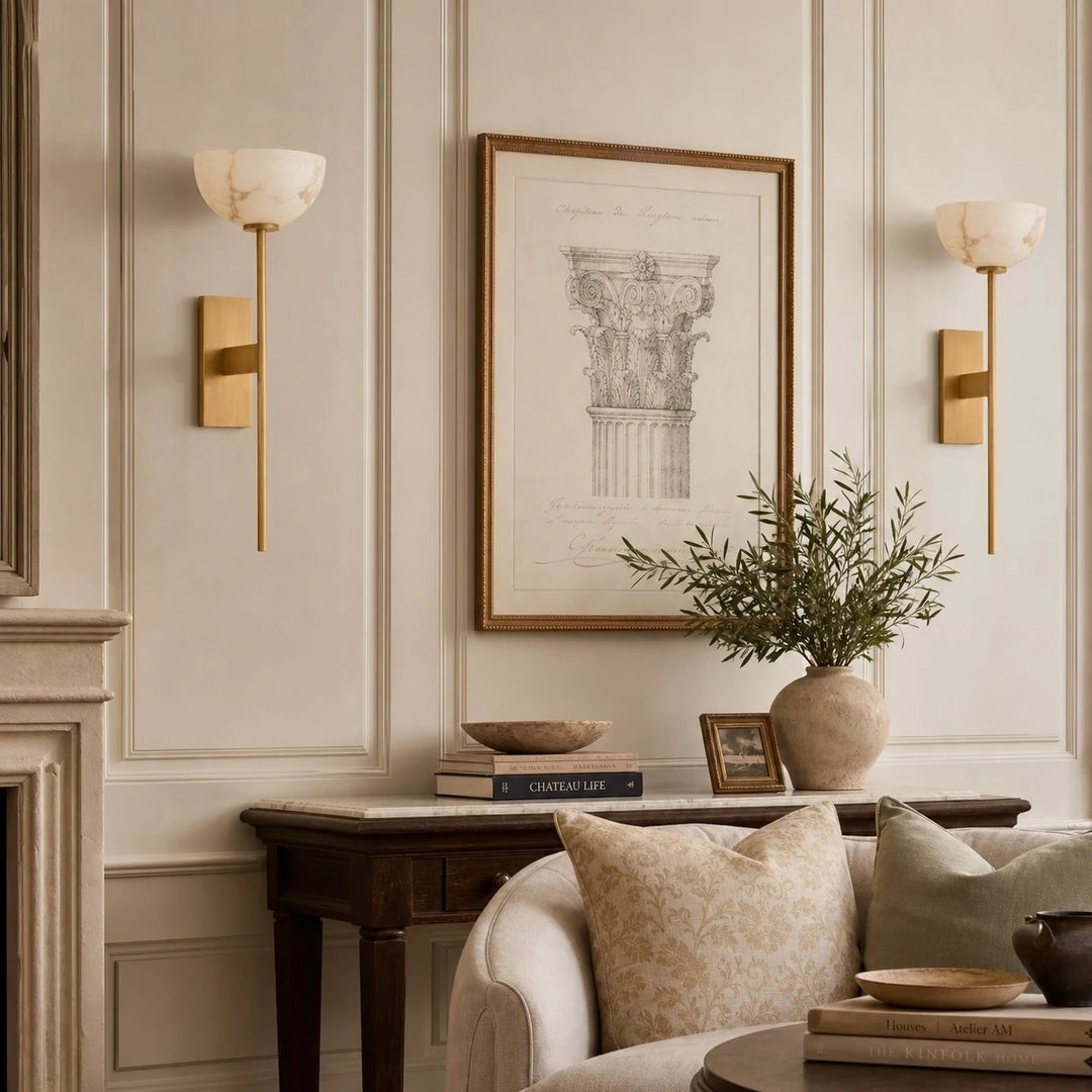 Natural brass wall sconces beside framed art
