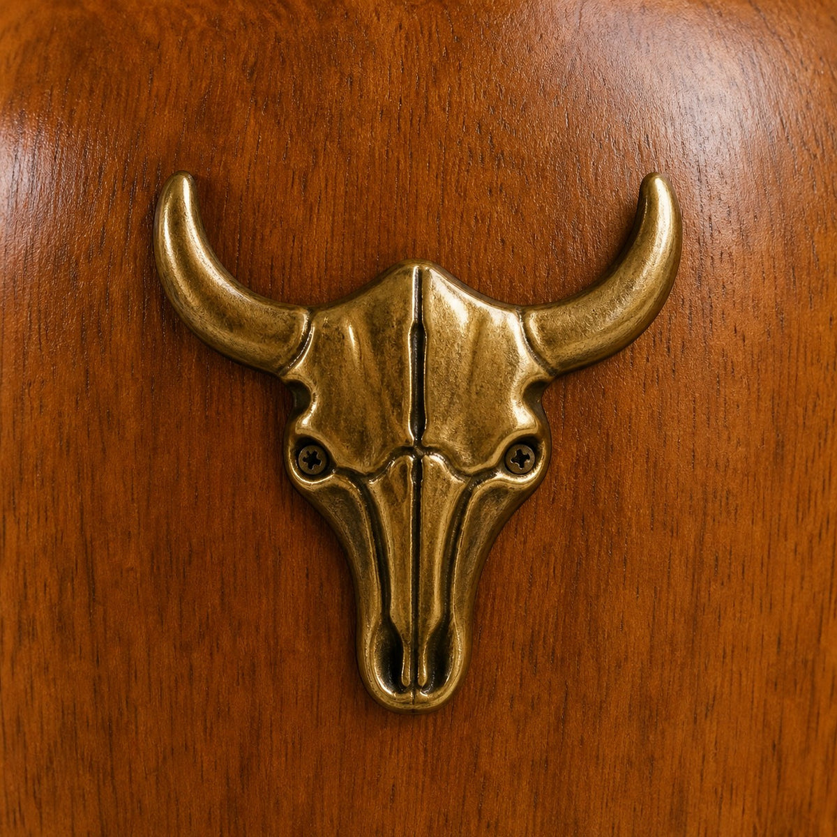 Brass bull-head accent on the wood lamp body