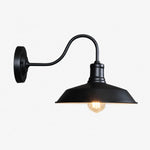 Cargar imagen en el visor de la Galería, Black wall sconce with warm light on white background