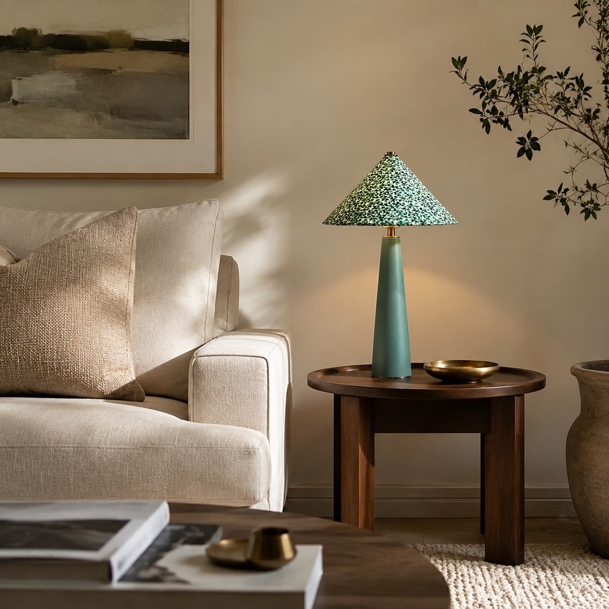 Green floral table lamp beside a sofa