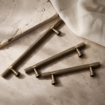 Afbeelding laden in galerijweergave, Antique brass cabinet pulls grouped on stone surface