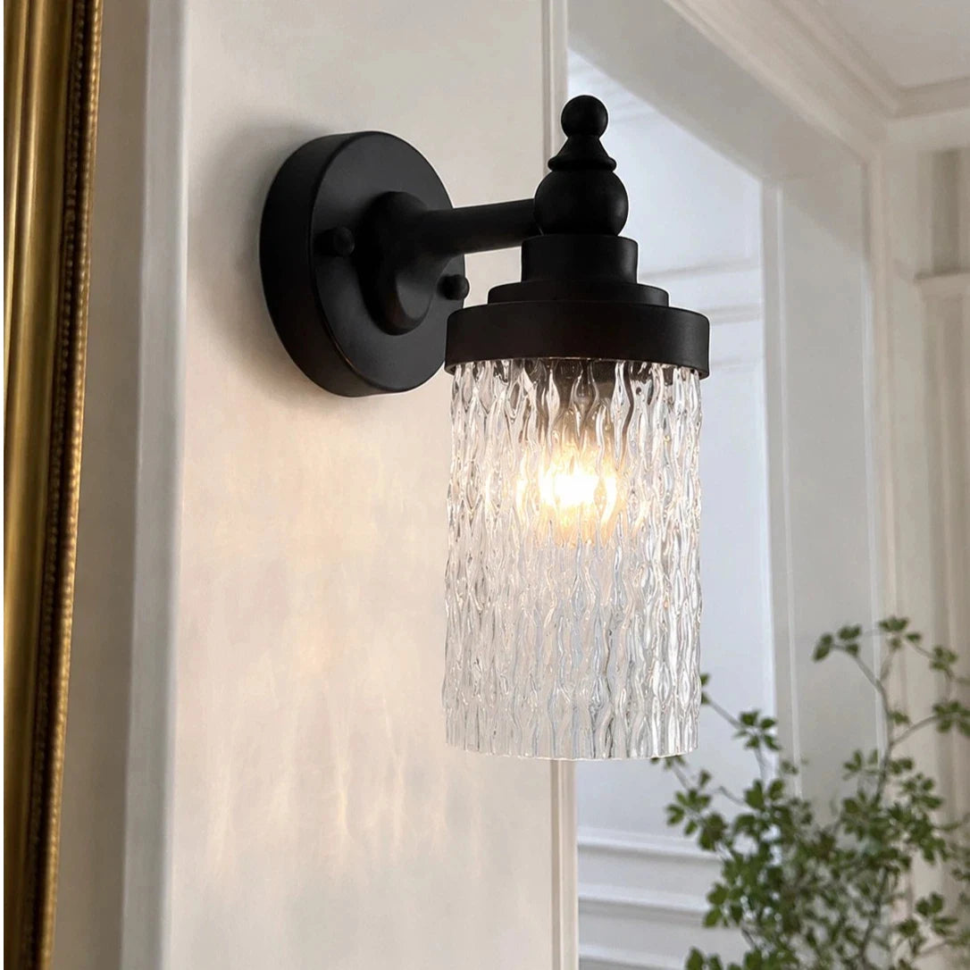 Averra ribbed glass outdoor wall sconce installed beside a covered porch wall