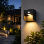 Load image into Gallery viewer, Style D black outdoor wall lamp with warm downlight on exterior wall