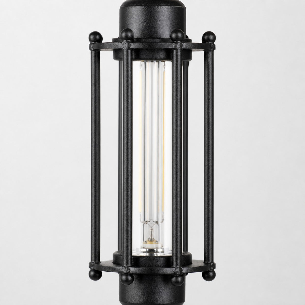 Close view of black tube guard frame and glass shade