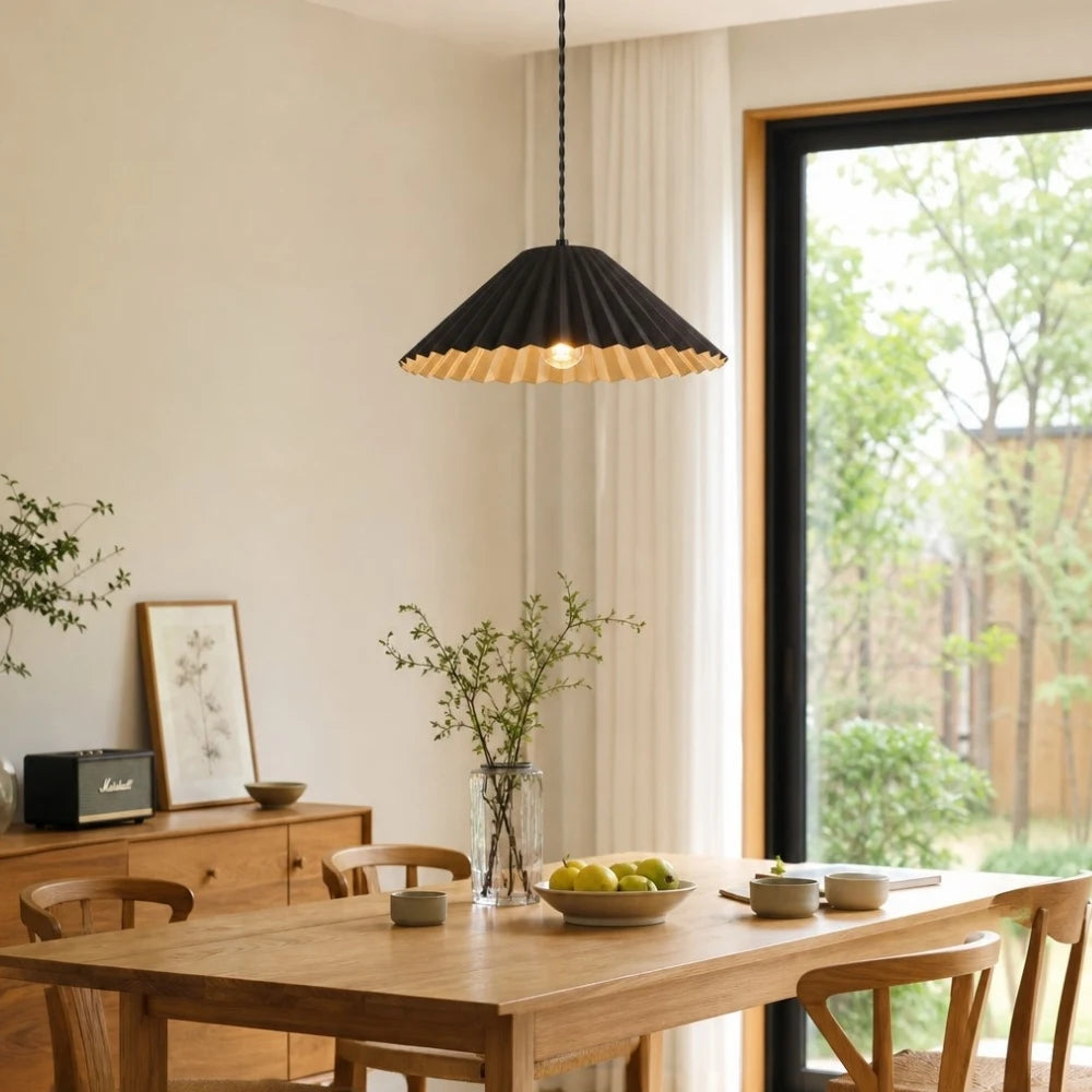 Black metal dome pendant lamp over a dining table