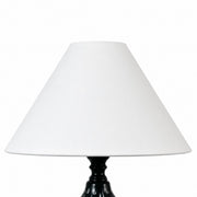 White fabric shade detail on ceramic table lamp