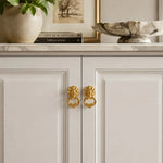 Afbeelding laden in galerijweergave, Brass ring pulls on white cabinet doors