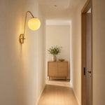 Cargar imagen en el visor de la Galería, Brass glass wall light installed along a hallway wall