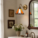 Cargar imagen en el visor de la Galería, Orange stained glass wall sconce in a bedside nook