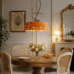 Cargar imagen en el visor de la Galería, Orange metal and ceramic pendant light installed above a round dining table