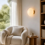 Cargar imagen en el visor de la Galería, Cream ribbed glass wall lamp beside a lounge chair