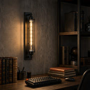 Industrial tube wall sconce beside shelves and books
