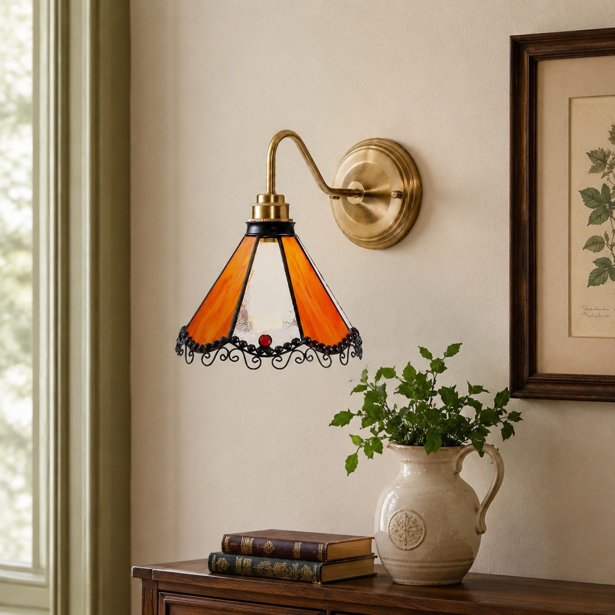Orange stained glass wall sconce on a framed art wall