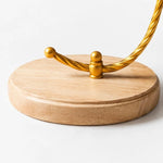 Cargar imagen en el visor de la Galería, Close detail of the round wood base and twisted gold support