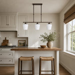 Bild in die Galerieansicht laden, Strellux three-head Coffee Brown chandelier over a compact kitchen bar