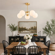 Gold five-light chandelier in a dining room