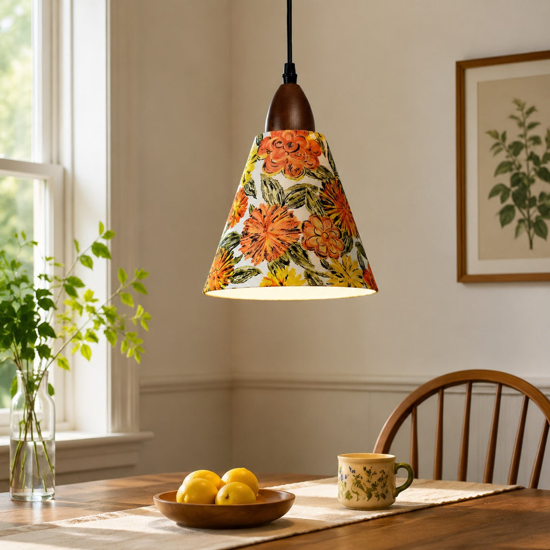 Orange floral pendant above sunlit wooden dining table