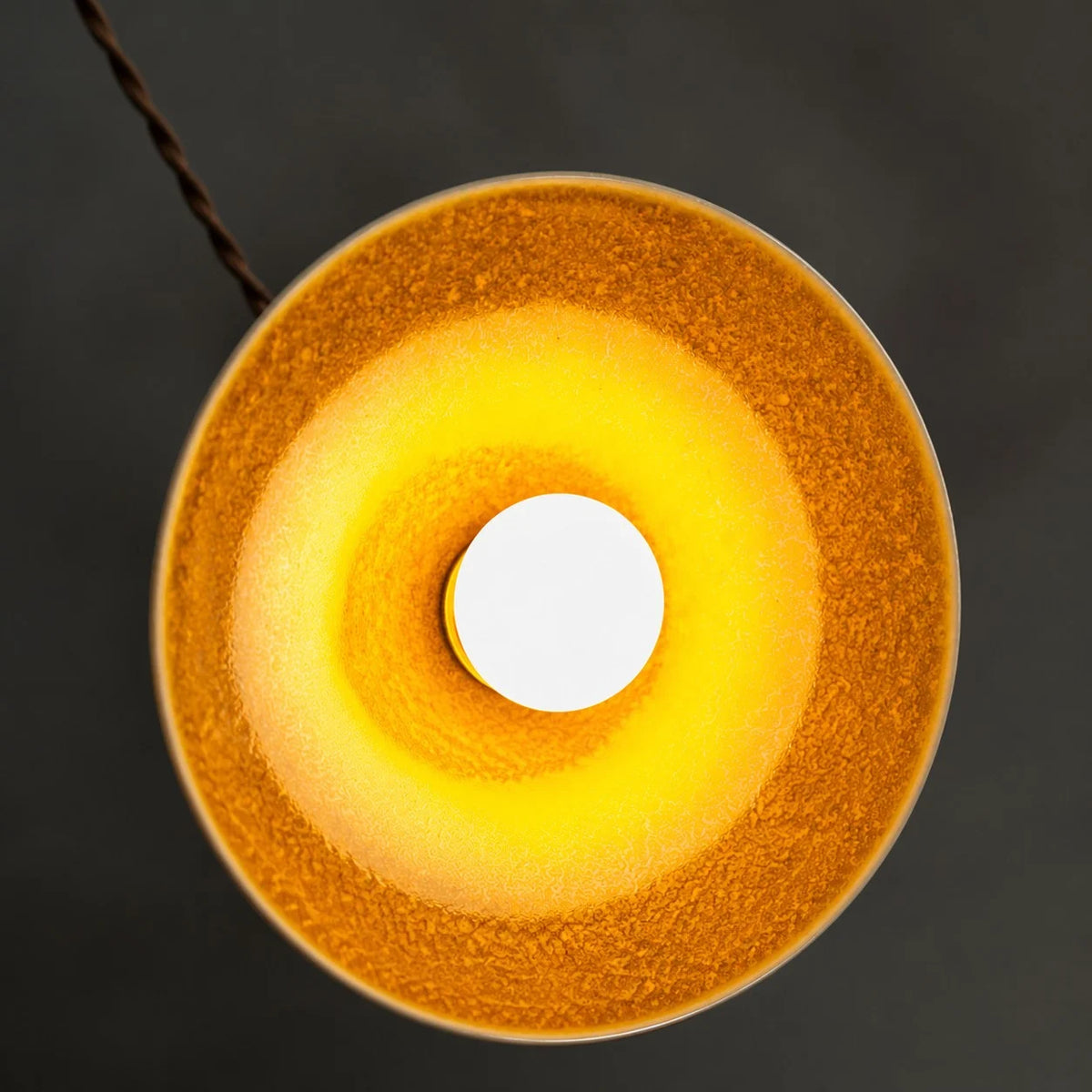 Underside view of the yellow ceramic glaze and open bulb area