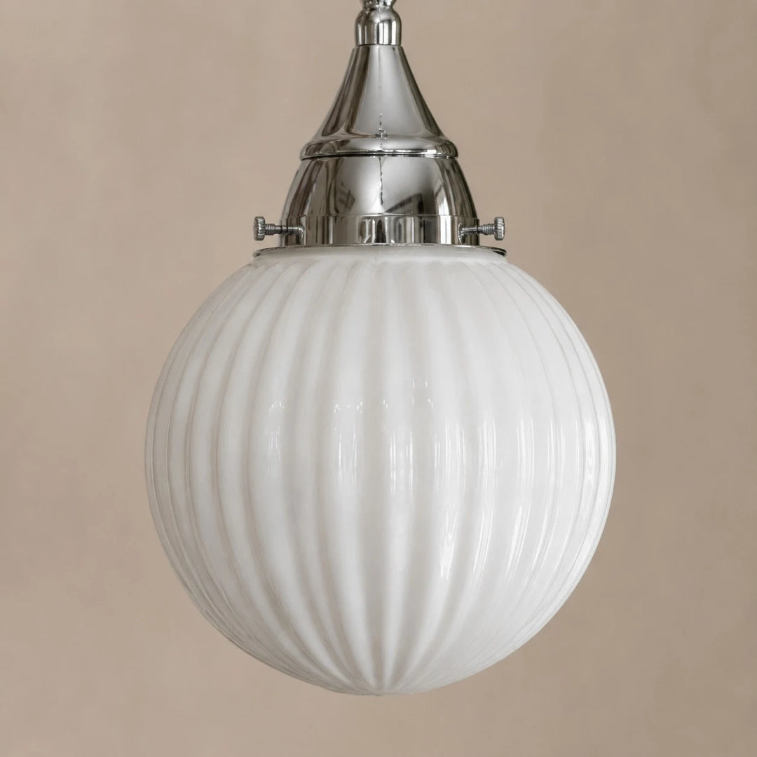 Close view of ribbed glass shade and metal cap