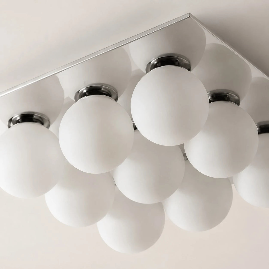 Detail image: frosted glass globes and chrome lamp holders.