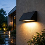 Charger l'image dans la visionneuse de la galerie, Black sloped outdoor wall light illuminated on a clean background