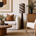 Cargar imagen en el visor de la Galería, Striped floor lamp in a cozy reading corner with chair and art wall