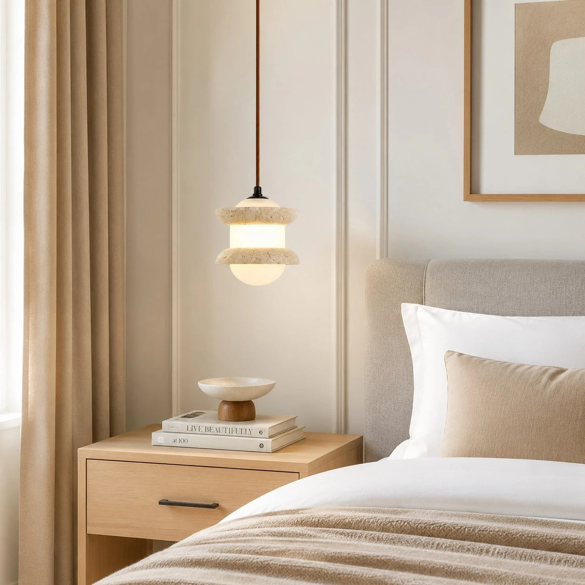 Single travertine stone pendant light beside a bed