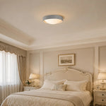 Load image into Gallery viewer, Gray flush mount ceiling light in a soft bedroom setting