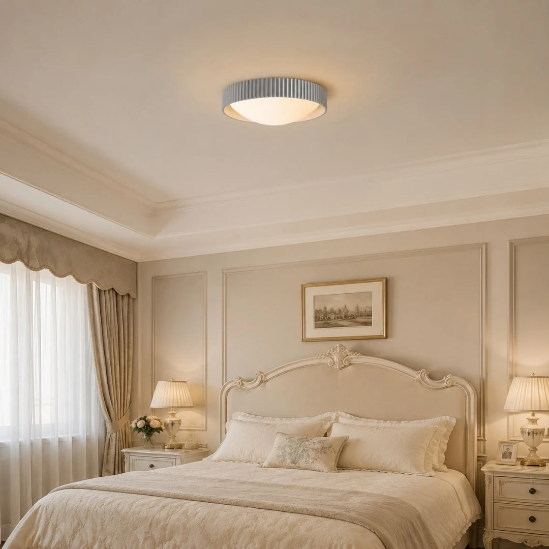 Gray flush mount ceiling light in a soft bedroom setting