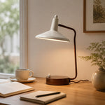 Bild in die Galerieansicht laden, Ivory and brown desk lamp illuminating an open book by a window