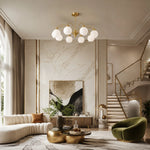 Load image into Gallery viewer, Glass globe chandelier above a marble living area