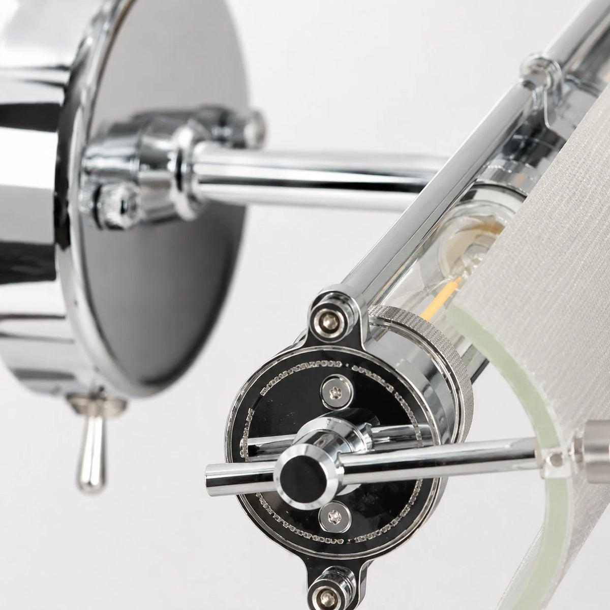 Adjustable joint and chrome hardware detail on the wall light