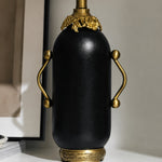 Charger l'image dans la visionneuse de la galerie, Close-up of matte black table lamp with antique brass-toned handles
