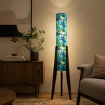Carica l'immagine nella visualizzazione Galleria, Multicolor striped tripod floor lamp in a warm room setting