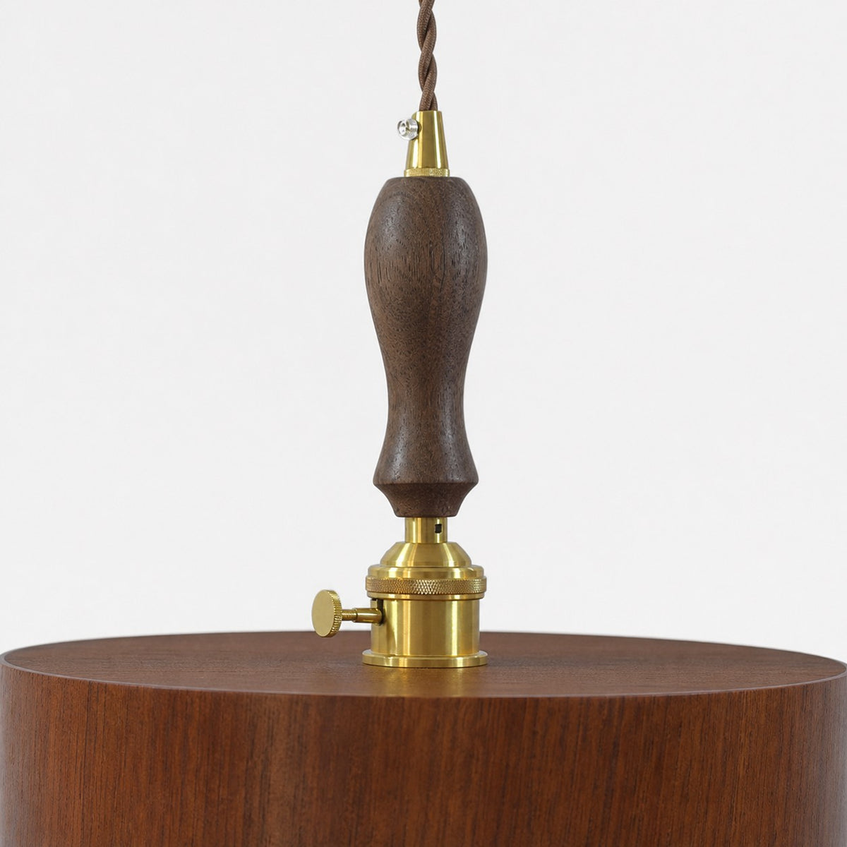 Turned dark wood suspension grip and brass-tone pendant hardware