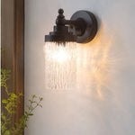 Cargar imagen en el visor de la Galería, Averra matte black wall sconce casting warm light near an entryway