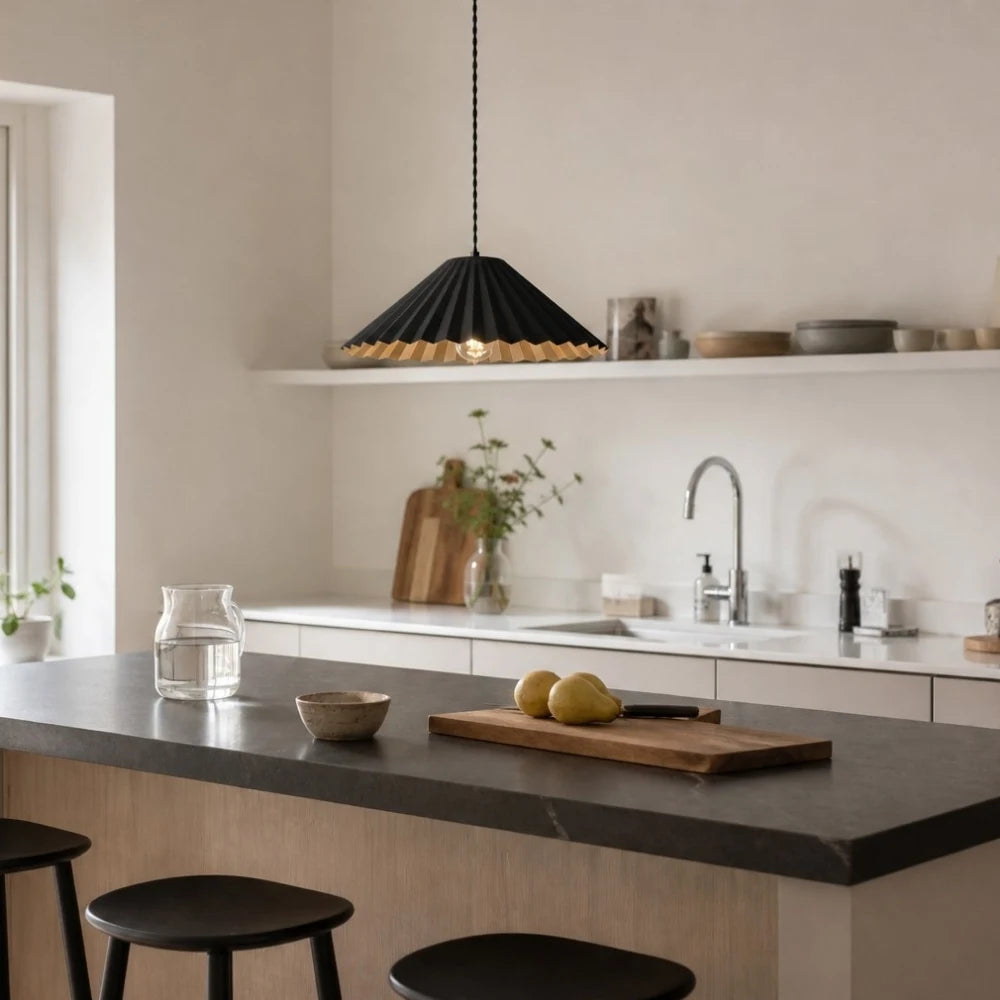 Black metal dome pendant lamp above a kitchen island