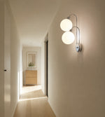Afbeelding laden in galerijweergave, Milk coffee globe wall lamp mounted beside a bedroom nightstand